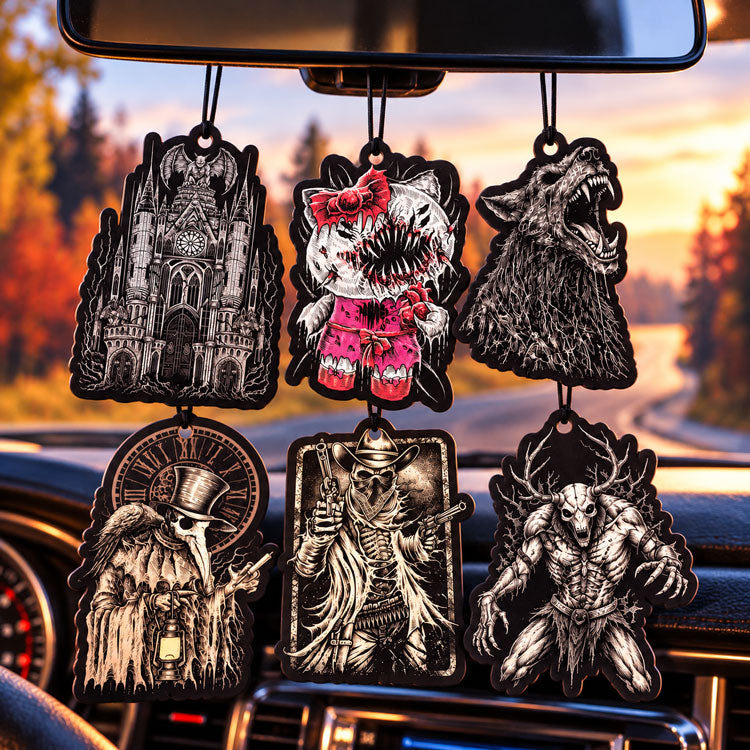 Six gothic horror car air fresheners featuring a gargoyle cathedral, monstrous cat, werewolf, plague doctor, skeleton cowboy, and horned creature hanging inside a car against a sunset road backdrop.