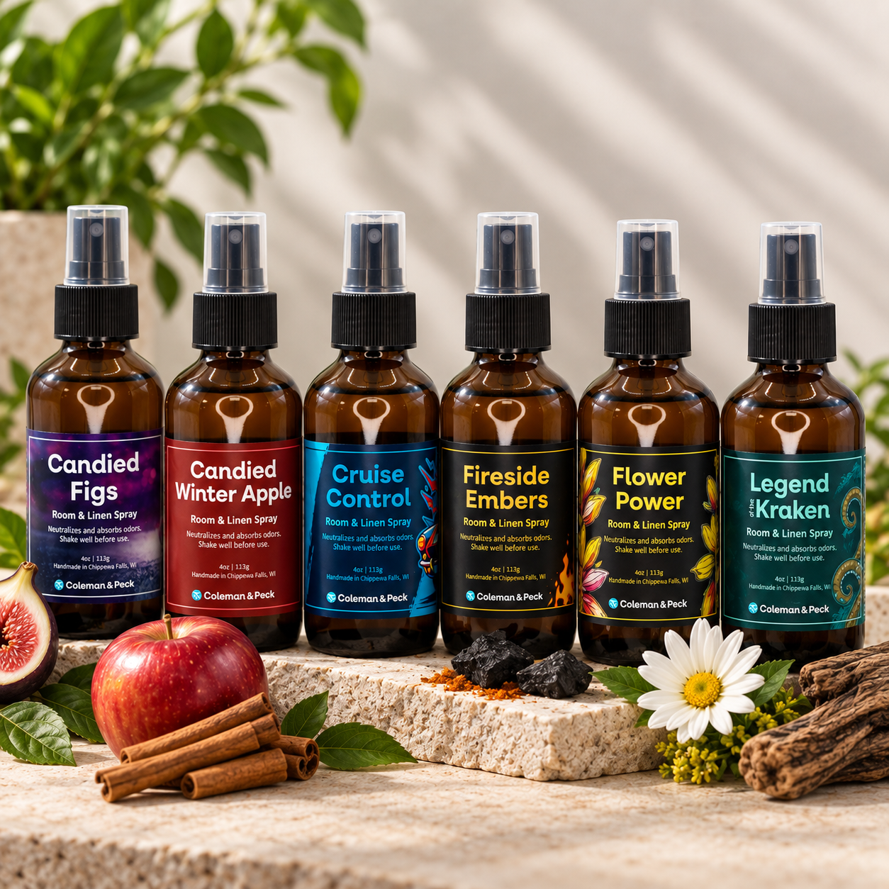 Six Ope! It’s Soap room and linen sprays in amber bottles, displayed with figs, apple, cinnamon, flowers, charcoal, greenery, and natural wood accents.