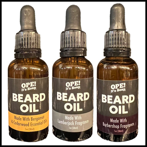 A lineup of three beard oils bottles, including bergamot and cedarwood, luberjack fragrance, and barbershop fragrance.