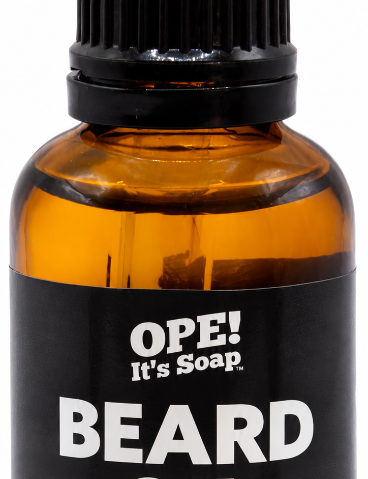 Amber glass Barbershop Beard Oil bottle with black dropper and a black and charcoal label featuring the Ope! It’s Soap logo.
