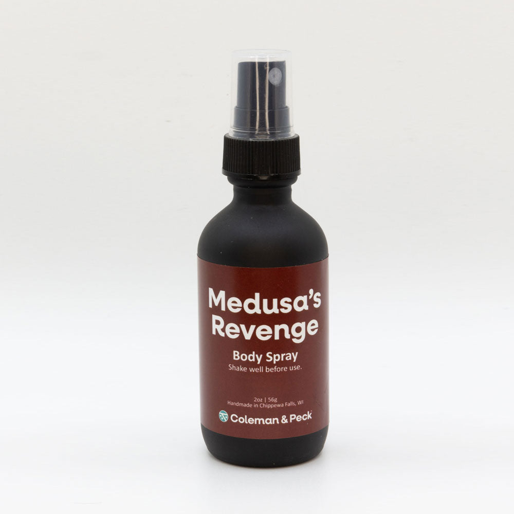 2oz black frosted glass spray bottle with red label featuring Medusa's Revenge Body Spray.