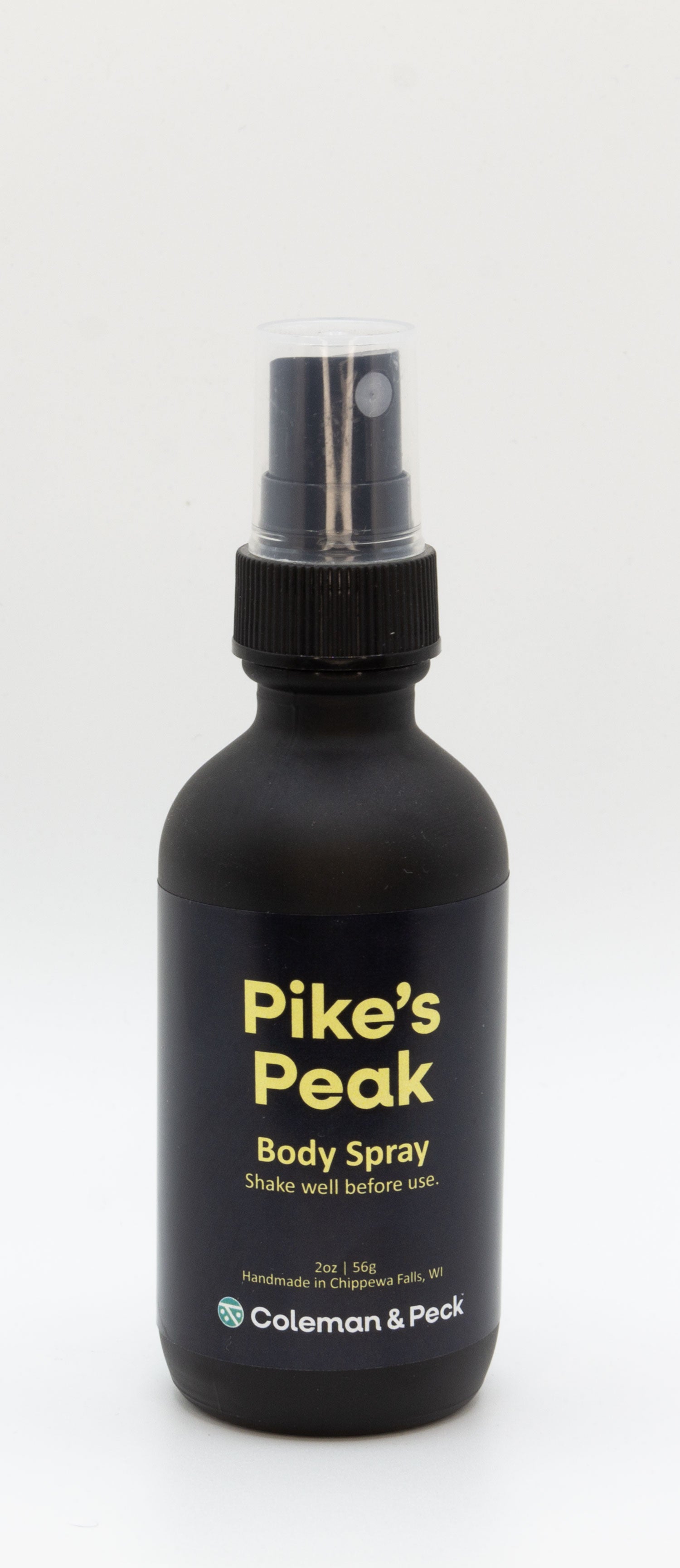 2oz black frosted glass spray bottle. Label reads Pike's Peak Body Spray.