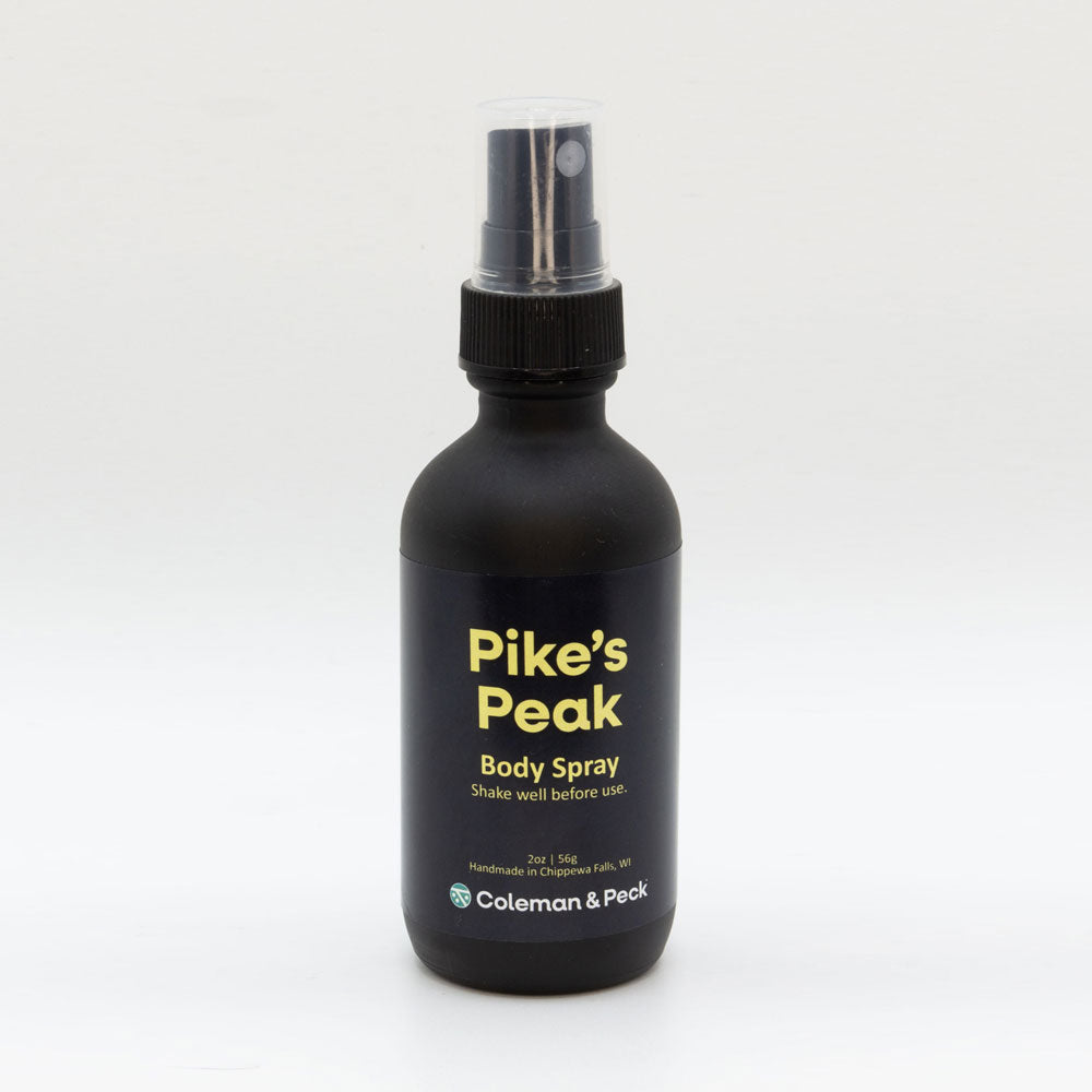 2oz black frosted glass spray bottle. Label reads Pike's Peak Body Spray.