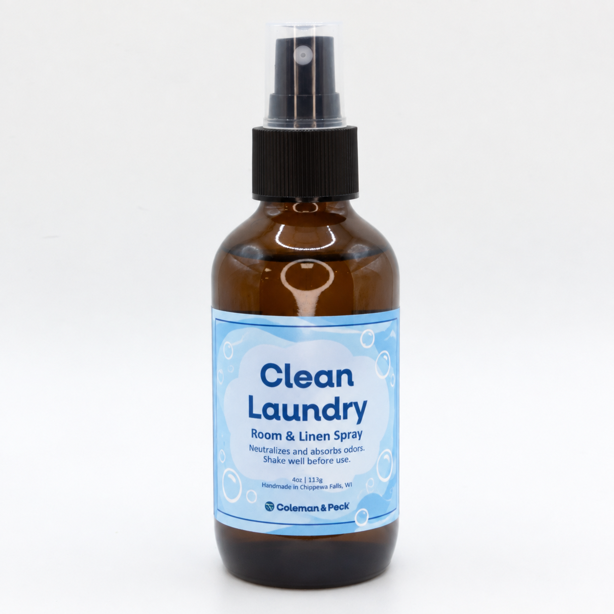 Clean Laundry Room & Linen Spray in an amber spray bottle with a light blue label, handmade by Coleman & Peck in Chippewa Falls, Wisconsin.