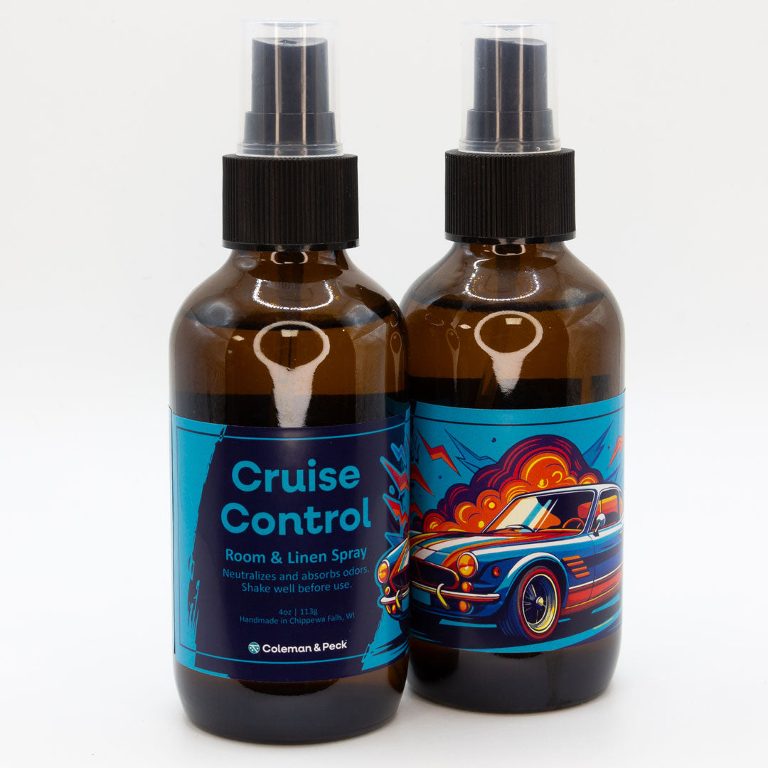 A pair of Cruise Control room & linen spray bottles, showing both sides of the label.