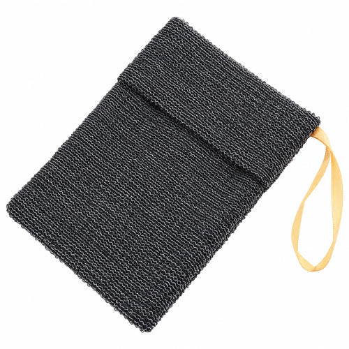 Black textured nylon exfoliating soap saver bag with a folded opening and gold hanging loop, shown diagonally on a white background.