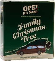 Ope! It’s Soap Family Christmas Tree soap box featuring a station wagon hauling an oversized Christmas tree against dark green packaging, with the tagline “Looks great! Little full. Lotta sap.”