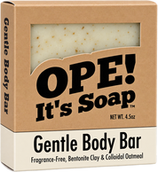 Ope! It’s Soap Gentle Body Bar box featuring a fragrance-free soap made with bentonite clay and colloidal oatmeal, with the light cream, oatmeal-speckled bar visible through the packaging window.