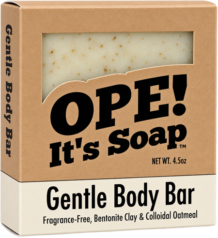 Ope! It’s Soap Gentle Body Bar box featuring a fragrance-free soap made with bentonite clay and colloidal oatmeal, with the light cream, oatmeal-speckled bar visible through the packaging window.