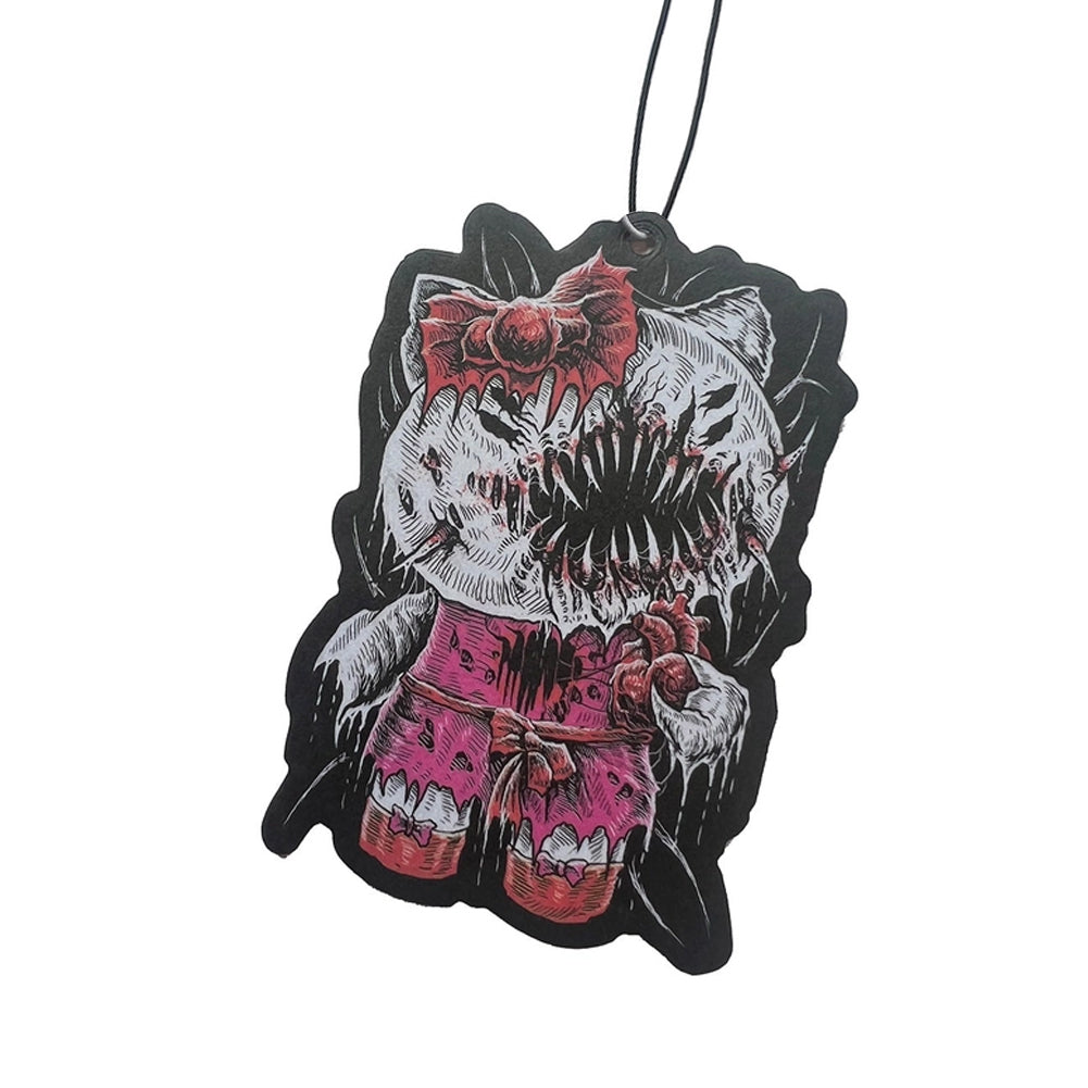 A novelty car air freshener or hanging tag featuring a horror-style illustration of a cat-like monster with a large open mouth showing sharp teeth, wearing a red bow and pink shorts, on a black background with a black hanging string.