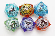 Six colorful translucent resin D20 dice from Foam Brain Games Snow Quest Mystery Loot collection, featuring snowman character faces inside each die. Dice are turquoise, amber, blue, green, purple, and orange, with silver numbering, arranged on a white background.