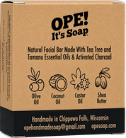 Back of the Ope! It’s Soap Natural Facial Bar box featuring tea tree and tamanu essential oils with activated charcoal, ingredient illustrations, and “Handmade in Chippewa Falls, Wisconsin.”