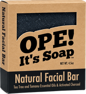 Ope! It’s Soap Natural Facial Bar box featuring a dark activated charcoal soap visible through the package window, made with tea tree and tamanu essential oils and activated charcoal.