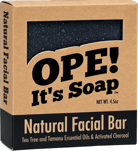 Ope! It’s Soap Natural Facial Bar box featuring a dark activated charcoal soap visible through the package window, made with tea tree and tamanu essential oils and activated charcoal.