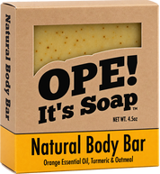 Ope! It’s Soap Natural Body Bar box featuring a kraft paper design with a window showing the golden, speckled soap and a mustard yellow label reading “Orange Essential Oil, Turmeric & Oatmeal.”