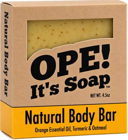 Ope! It’s Soap Natural Body Bar box featuring a kraft paper design with a window showing the golden, speckled soap and a mustard yellow label reading “Orange Essential Oil, Turmeric & Oatmeal.”