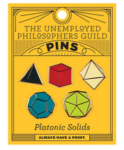 Set of five colorful Platonic Solids enamel pins representing D4, D6, D8, D12, and D20 dice in black, red, cream, teal, and green, displayed on yellow Unemployed Philosophers Guild packaging.
