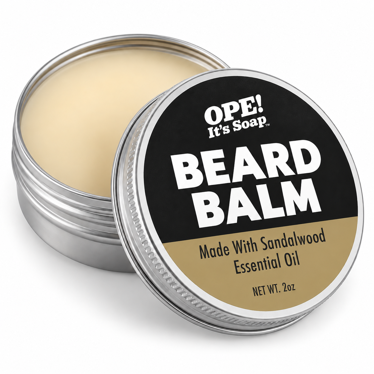 An open round metal tin of OPE! It's Soap Beard Balm, showing the pale cream balm inside, with the lid leaning in front. The lid features a black and tan label with bold white text.