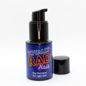 Front of Totally Rad Hair Dry Shampoo for Light Hair, made by Coleman and Peck. This view shows the cap off the pump, revealing the nozzle of the sprayer.