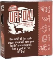 Back of the Ope! It’s Soap Uff Da soap box featuring a buck in a Northwoods scene, red French clay and oil ingredient illustrations, and the tagline “One whiff of this rustic woods soap will have you feelin’ more majestic than a buck in rut. Uff Da!”