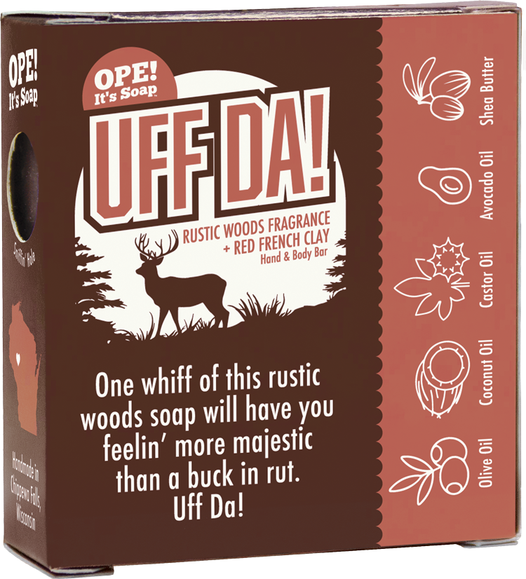 Back of the Ope! It’s Soap Uff Da soap box featuring a buck in a Northwoods scene, red French clay and oil ingredient illustrations, and the tagline “One whiff of this rustic woods soap will have you feelin’ more majestic than a buck in rut. Uff Da!”