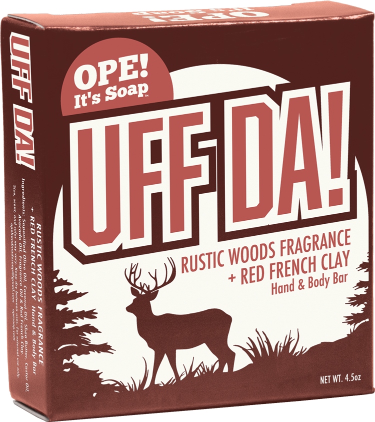 Ope! It’s Soap Uff Da hand and body bar box featuring rustic red and cream packaging with a buck and Northwoods scenery, made with rustic woods fragrance and red French clay.