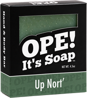 Ope! It’s Soap Up Nort’ hand and body bar in black and forest green packaging, with a window showing the speckled green soap bar inside.