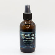 Front view of Woodland Hideaway room & linen spray bottle. A single bottle is shown.