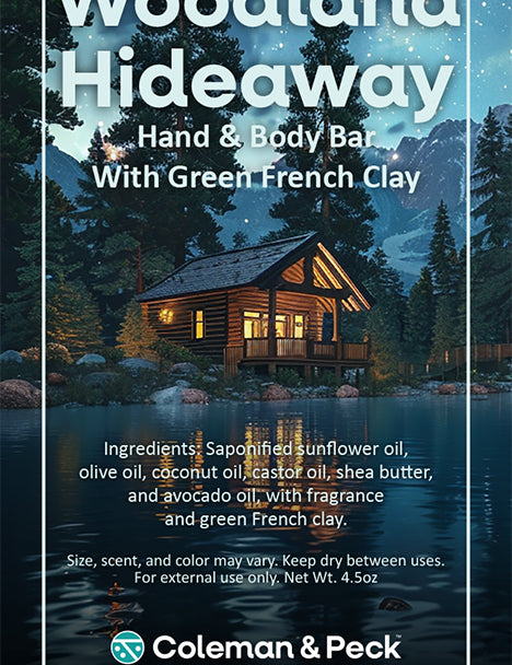 Woodland Hideaway soap ingredient card featuring an image of a cabin on a serene lake.