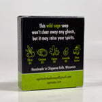Back side of the Opergeist soap box. Quote on box says, "This wild sage soap won't clear away any ghosts, but it may raise your spirits." Box is black with green accents.
