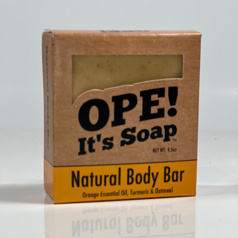Front side of the Natural Body Bar box. Box is kraft paper colored with orange accents.