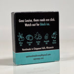 Back side of the Geez Louise soap. Quote on box says, "Geez Louise, them roads are slick. Watch out for black ice." Box is black with teal accents.