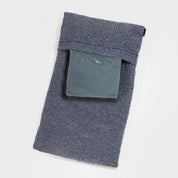 Photo of a single gray exfoliating soap bag, shown with a bar of soap being inserted.